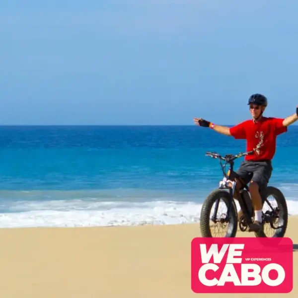 Image of a dual-motor electric bike on an off-road trail in Los Cabos, surrounded by desert scenery and clear blue skies.