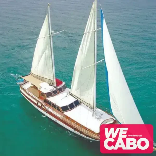 Image of a luxury yacht cruising at sunset in Cabo San Lucas, featuring a private chef dinner and premium bar, courtesy of WECABO.