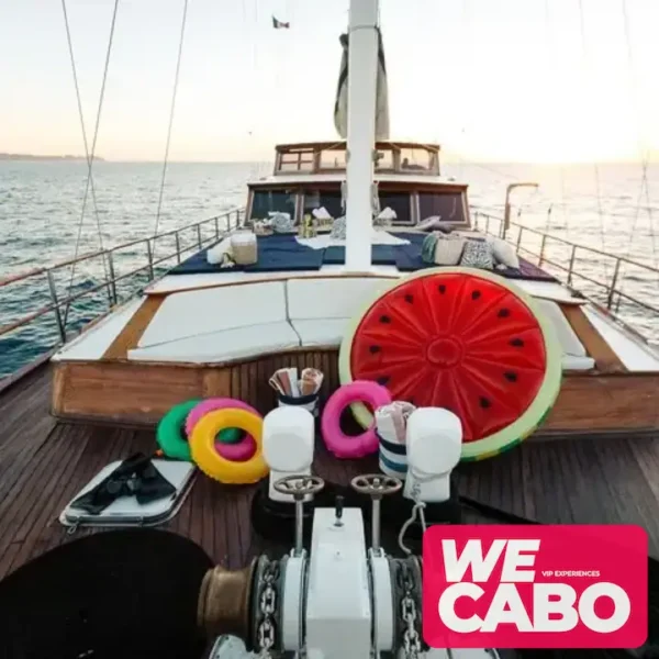 Image of a luxury yacht cruising at sunset in Cabo San Lucas, featuring a private chef dinner and premium bar, courtesy of WECABO.