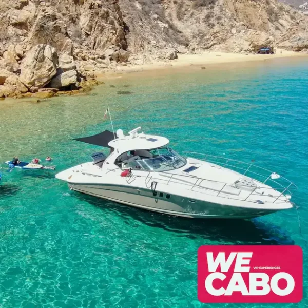 Image of a luxurious 45ft Sea Ray yacht cruising the crystal-clear waters of Cabo San Lucas, featuring spaces for relaxation, open bar, and gourmet menu.