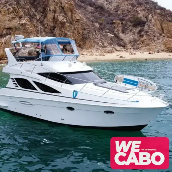 Image of a 42ft Silverton yacht cruising through the crystal-clear waters of Los Cabos, featuring an open bar, paddleboard, and snorkeling gear for a luxurious day at sea.