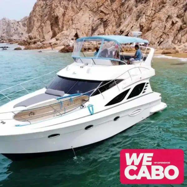 Image of a 42ft Silverton yacht cruising through the crystal-clear waters of Los Cabos, featuring an open bar, paddleboard, and snorkeling gear for a luxurious day at sea.