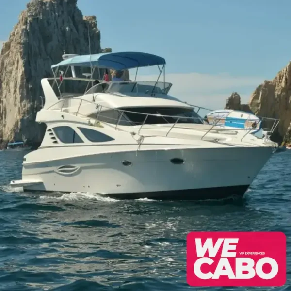 Image of a 42ft Silverton yacht cruising through the crystal-clear waters of Los Cabos, featuring an open bar, paddleboard, and snorkeling gear for a luxurious day at sea.