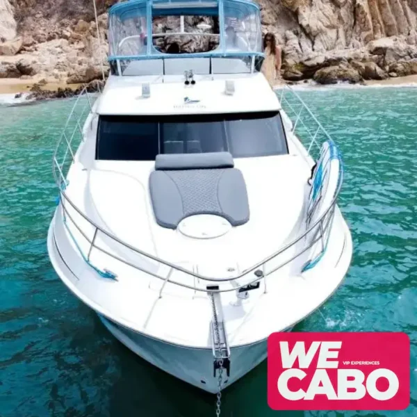 Image of a 42ft Silverton yacht cruising through the crystal-clear waters of Los Cabos, featuring an open bar, paddleboard, and snorkeling gear for a luxurious day at sea.